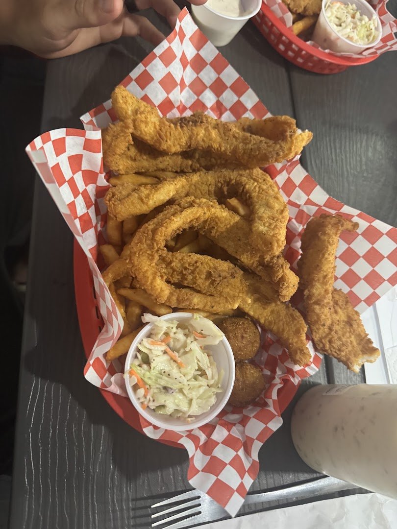 Crisp fish and chips beside coleslaw.